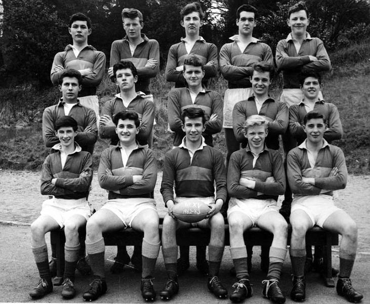 Scan1826.jpg - Rugby team with John Barry, First XV, 1962-63 Back Row: Charlie Duthie; Bill Smith; Chris Pope; Malcolm Wylie;  John Perrins; Vincent Delecato; John Muldoon; Ian o'Henley; Ian Adam; Leo Forsyth John Barry, John Baccigalupo; Joe Flaherty; Peter Cassidy; Roddy Zentil John Barry never played in this team - They were a man short on the day of the photograph and John just happened to be standing around waiting for his own team's photograph - probably the second xv in which you were playing that year.  John was sitting in for George Weresyowski